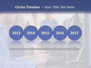 A Group Of People Standing Around A Computer Screen PowerPoint Template