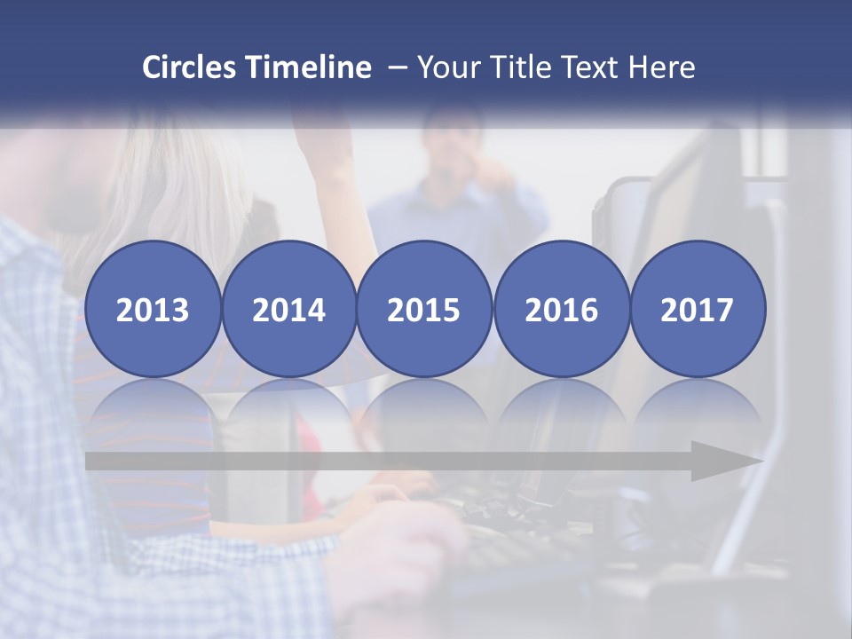 A Group Of People Standing Around A Computer Screen PowerPoint Template