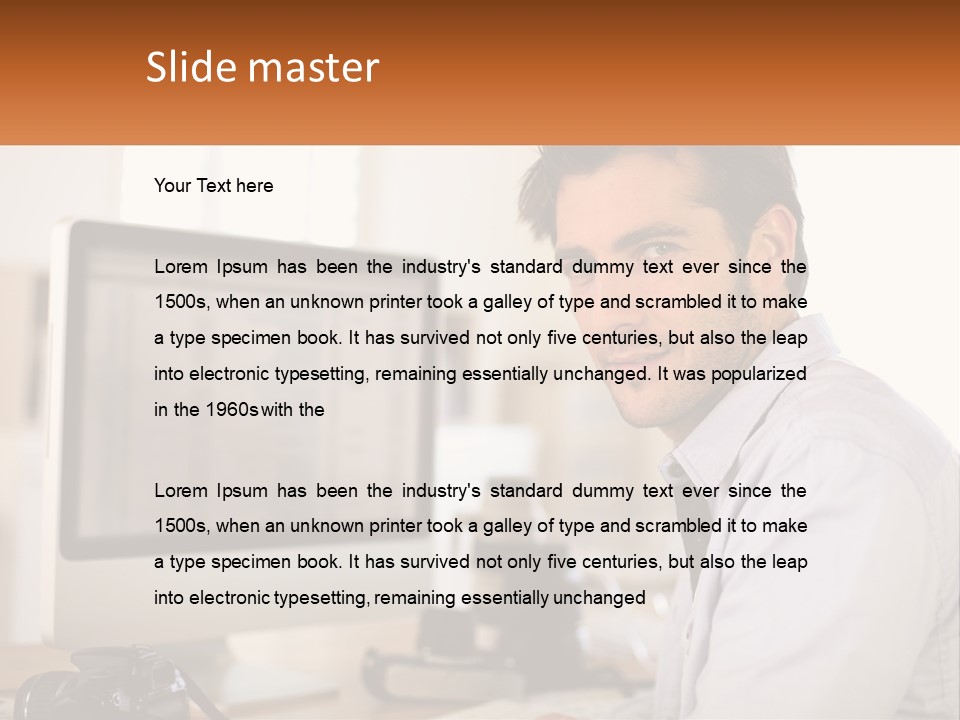 A Man Sitting At A Desk In Front Of A Computer PowerPoint Template