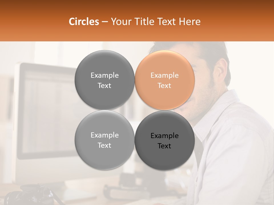 A Man Sitting At A Desk In Front Of A Computer PowerPoint Template