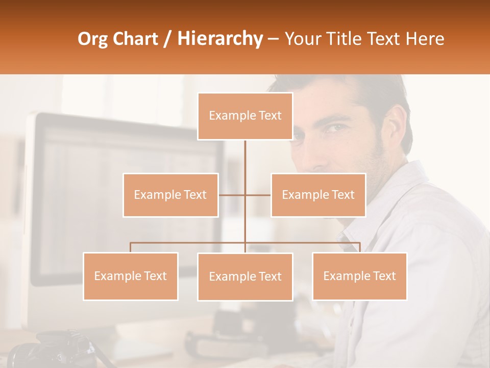 A Man Sitting At A Desk In Front Of A Computer PowerPoint Template