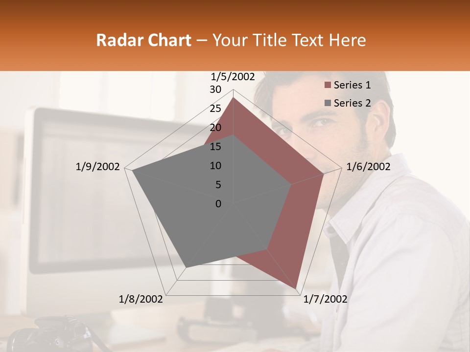 A Man Sitting At A Desk In Front Of A Computer PowerPoint Template