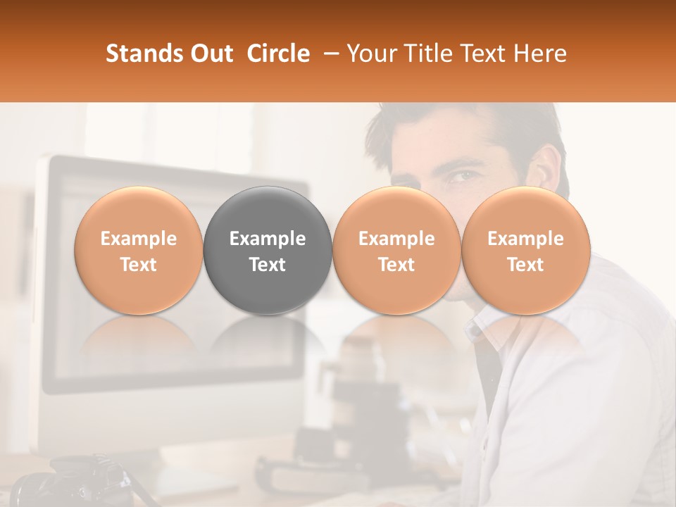 A Man Sitting At A Desk In Front Of A Computer PowerPoint Template