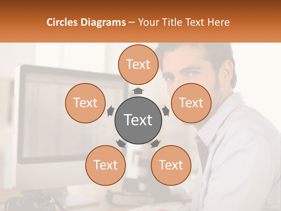 A Man Sitting At A Desk In Front Of A Computer PowerPoint Template