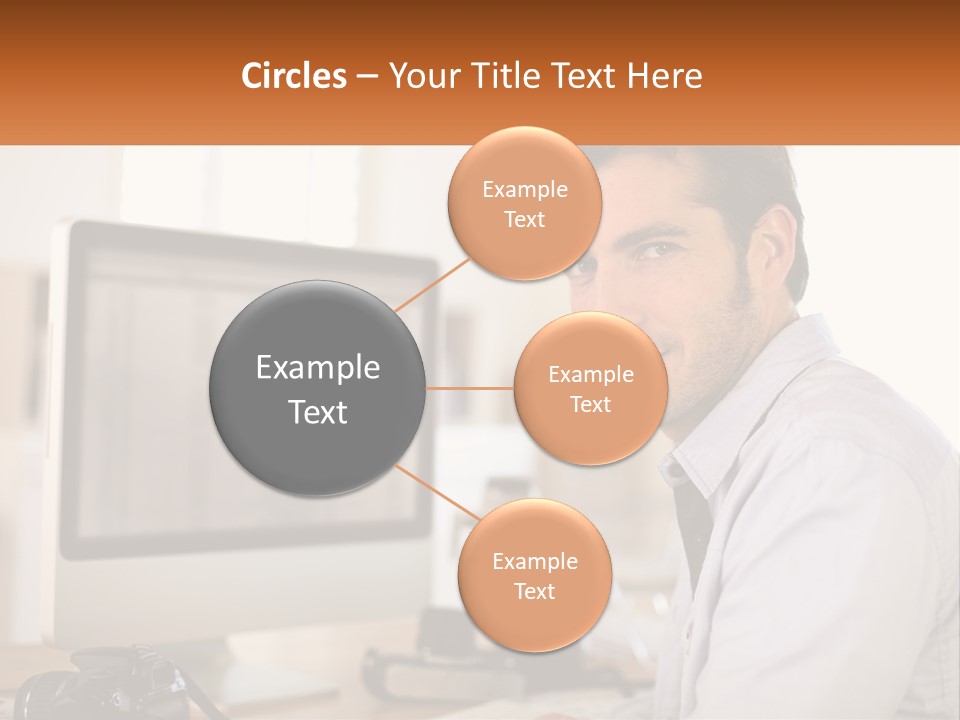 A Man Sitting At A Desk In Front Of A Computer PowerPoint Template