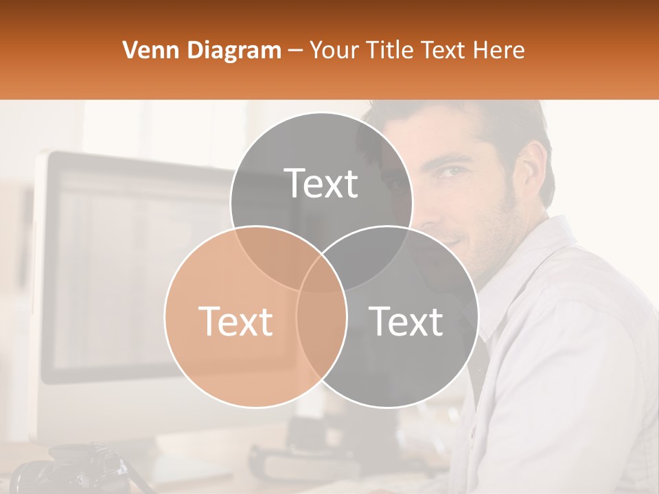 A Man Sitting At A Desk In Front Of A Computer PowerPoint Template