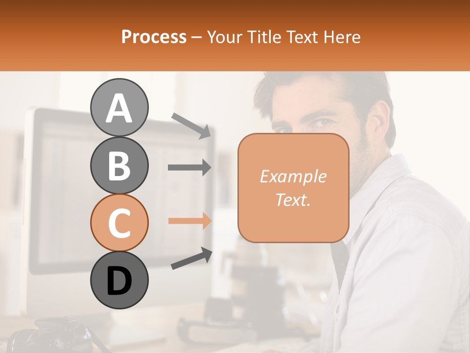 A Man Sitting At A Desk In Front Of A Computer PowerPoint Template