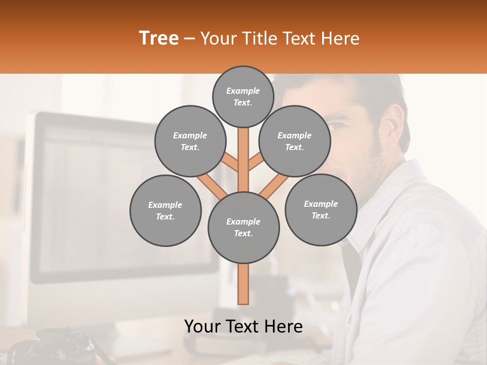 A Man Sitting At A Desk In Front Of A Computer PowerPoint Template