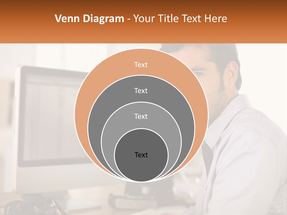 A Man Sitting At A Desk In Front Of A Computer PowerPoint Template