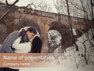 A Man And Woman Kissing In Front Of A Bridge PowerPoint Template