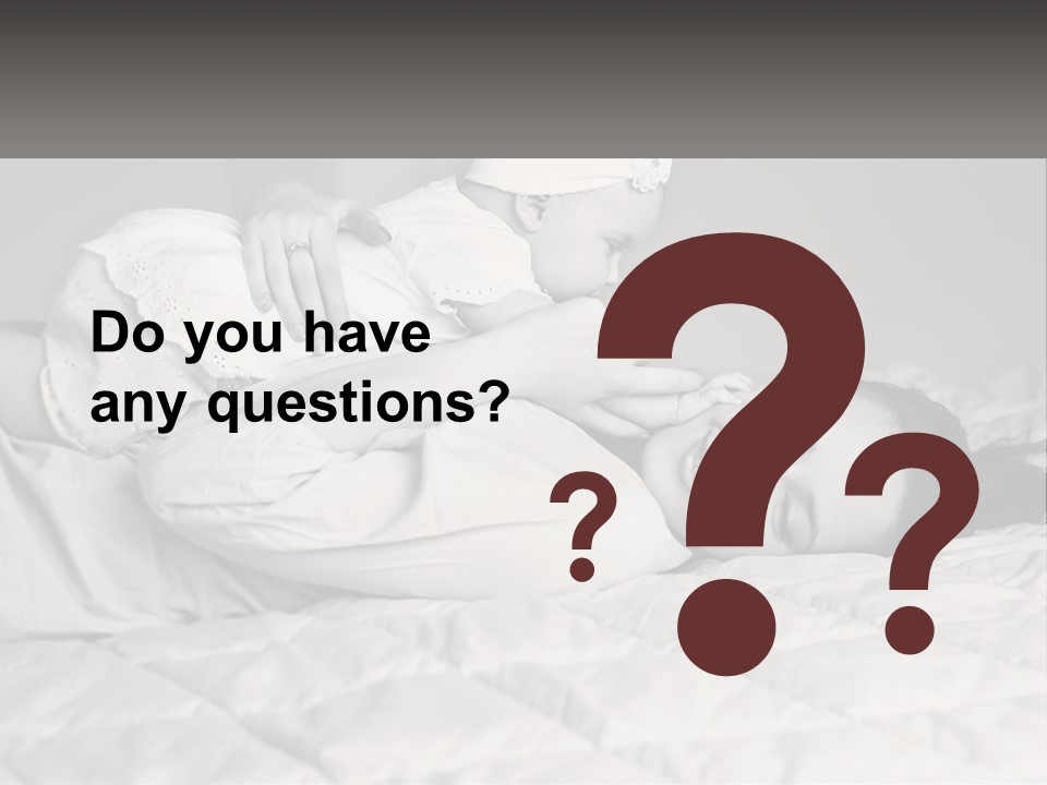 A Woman Laying On Top Of A Bed Holding A Baby PowerPoint Template