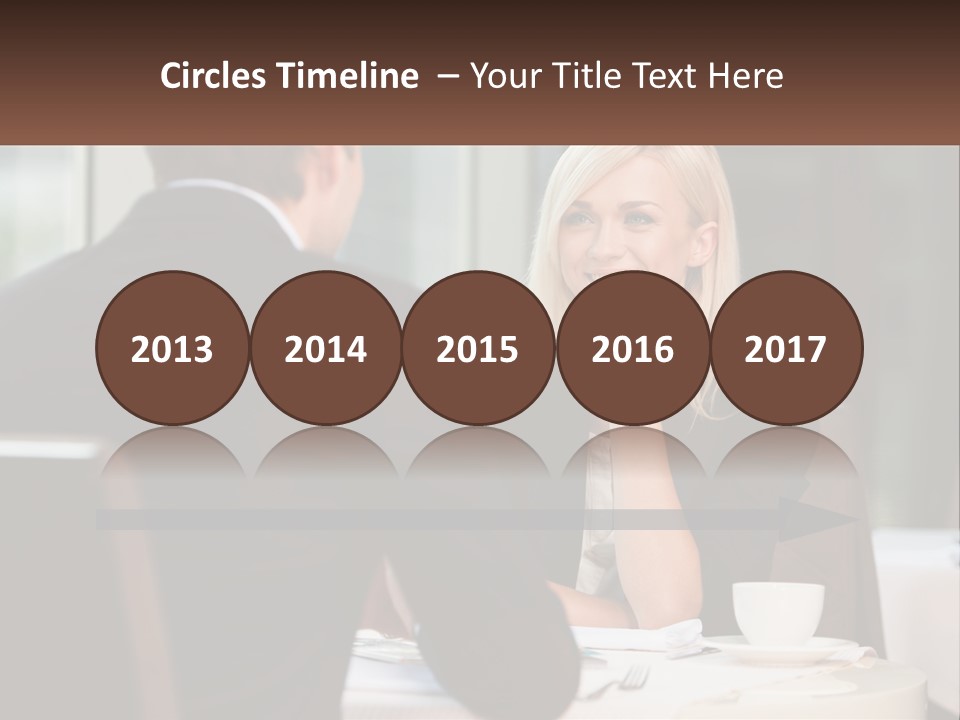 A Man And Woman Sitting At A Table Talking PowerPoint Template