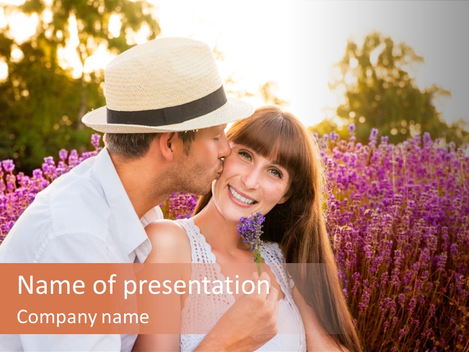 A Man Kissing A Woman In A Field Of Flowers PowerPoint Template