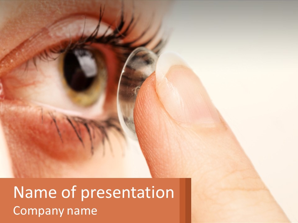 A Person Holding A Contact Lens Up To Their Eye PowerPoint Template