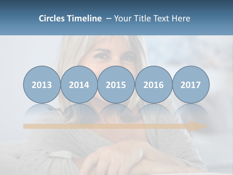 A Woman Sitting On A Couch Smiling For The Camera PowerPoint Template