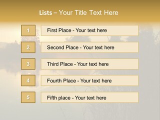 The Sun Is Setting Over A Lake With Reeds In The Foreground PowerPoint Template