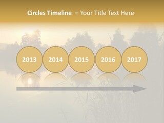 The Sun Is Setting Over A Lake With Reeds In The Foreground PowerPoint Template