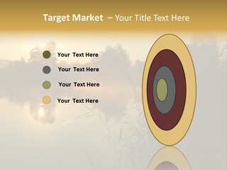 The Sun Is Setting Over A Lake With Reeds In The Foreground PowerPoint Template