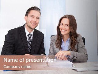 A Man And A Woman Sitting At A Desk PowerPoint Template