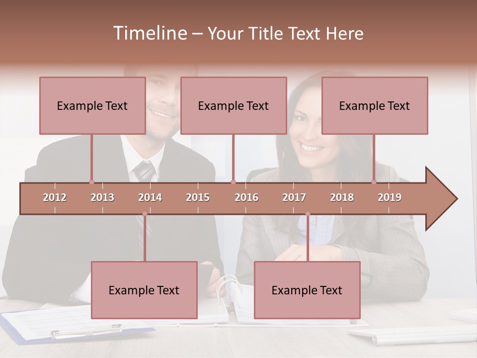 A Man And A Woman Sitting At A Desk PowerPoint Template