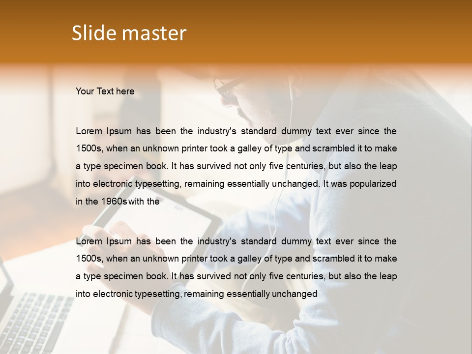 A Man Sitting In Front Of A Laptop Computer PowerPoint Template