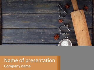 A Wooden Table Topped With A Cookie Cutter And Star Anise PowerPoint Template