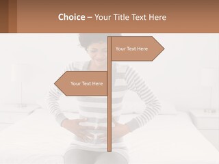 A Woman Standing On A Bed Holding Her Stomach PowerPoint Template