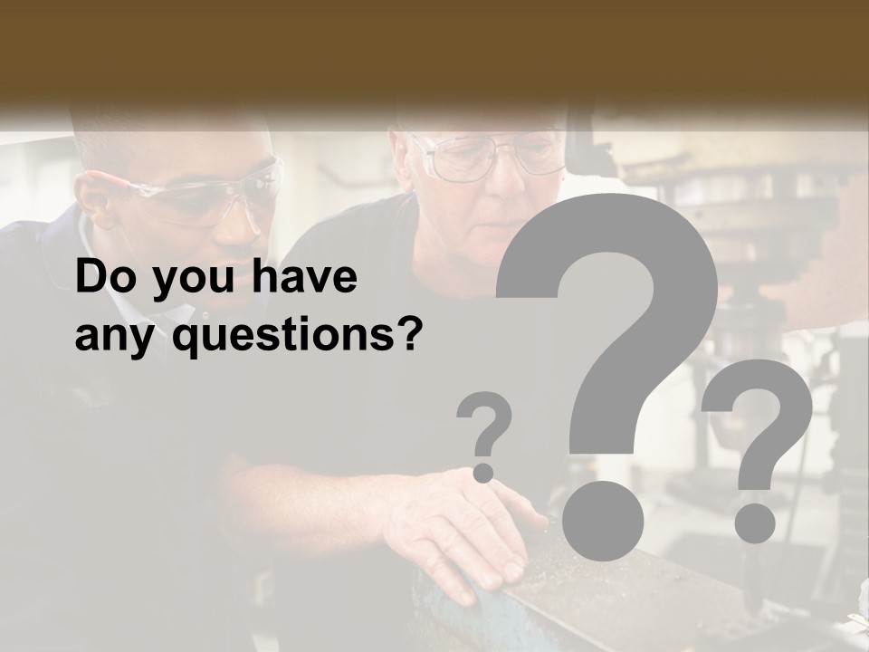 Two Men Working On A Machine In A Factory PowerPoint Template