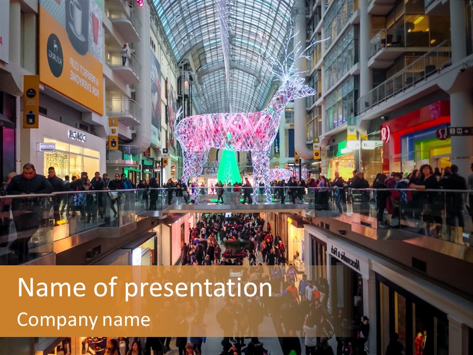 A Large Group Of People Walking Through A Mall PowerPoint Template