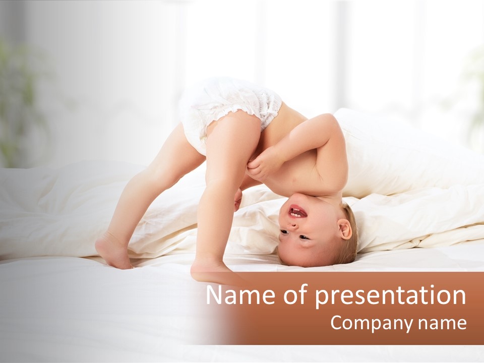 A Baby Laying On A Bed With A White Blanket PowerPoint Template