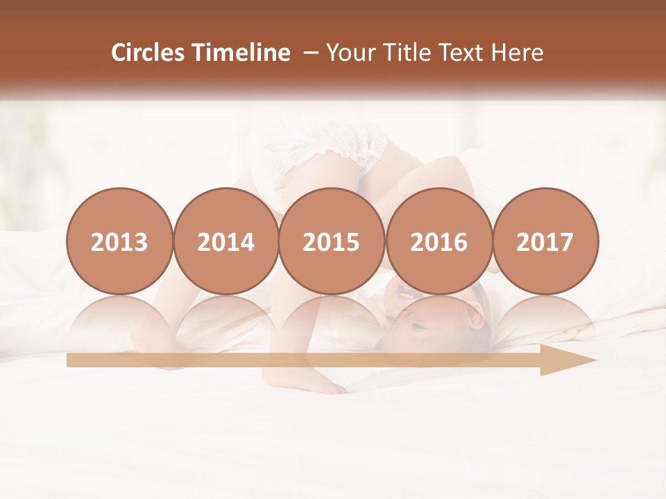 A Baby Laying On A Bed With A White Blanket PowerPoint Template