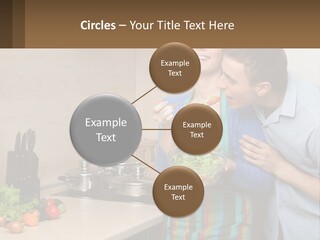 A Man And Woman Preparing Food In A Kitchen PowerPoint Template