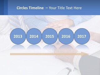 A Group Of People Sitting Around A Table With Papers PowerPoint Template