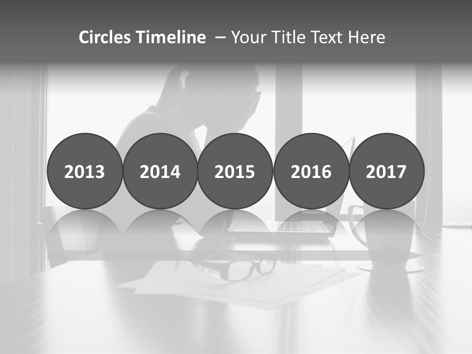 A Woman Sitting At A Desk With Her Head In Her Hands PowerPoint Template