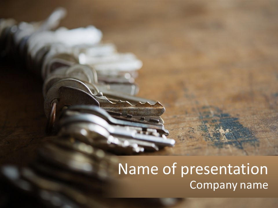 A Bunch Of Keys Sitting On Top Of A Wooden Table PowerPoint Template