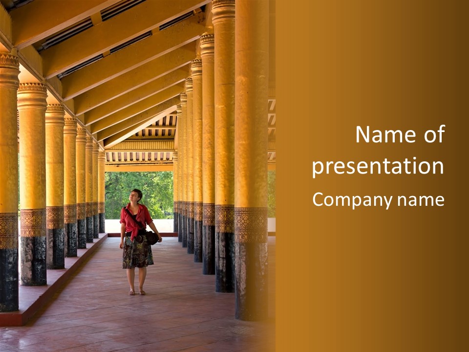 A Woman Walking Down A Walkway In A Building PowerPoint Template