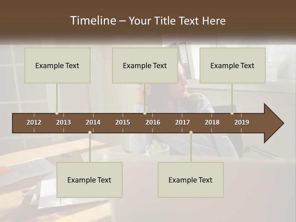 A Woman Sitting At A Desk In Front Of A Laptop Computer PowerPoint Template