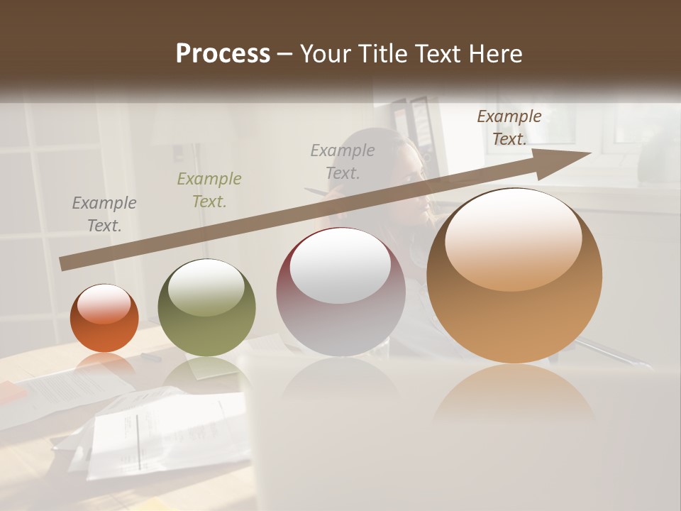 A Woman Sitting At A Desk In Front Of A Laptop Computer PowerPoint Template