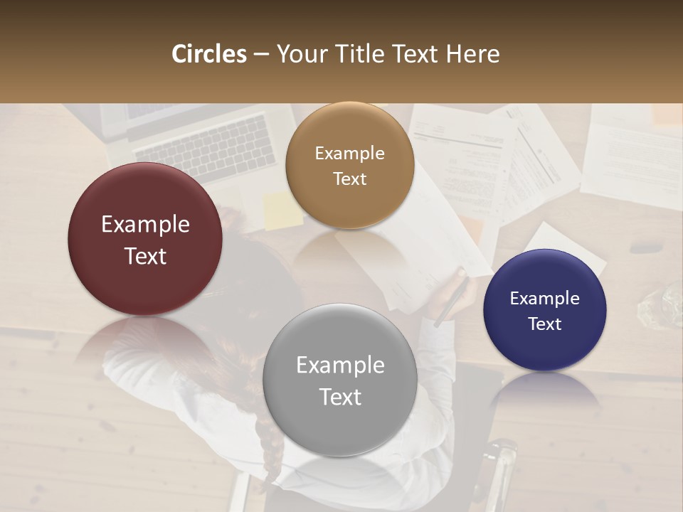 A Woman Sitting At A Desk With A Laptop And Papers PowerPoint Template