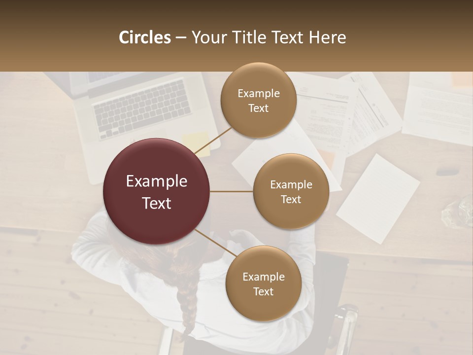 A Woman Sitting At A Desk With A Laptop And Papers PowerPoint Template