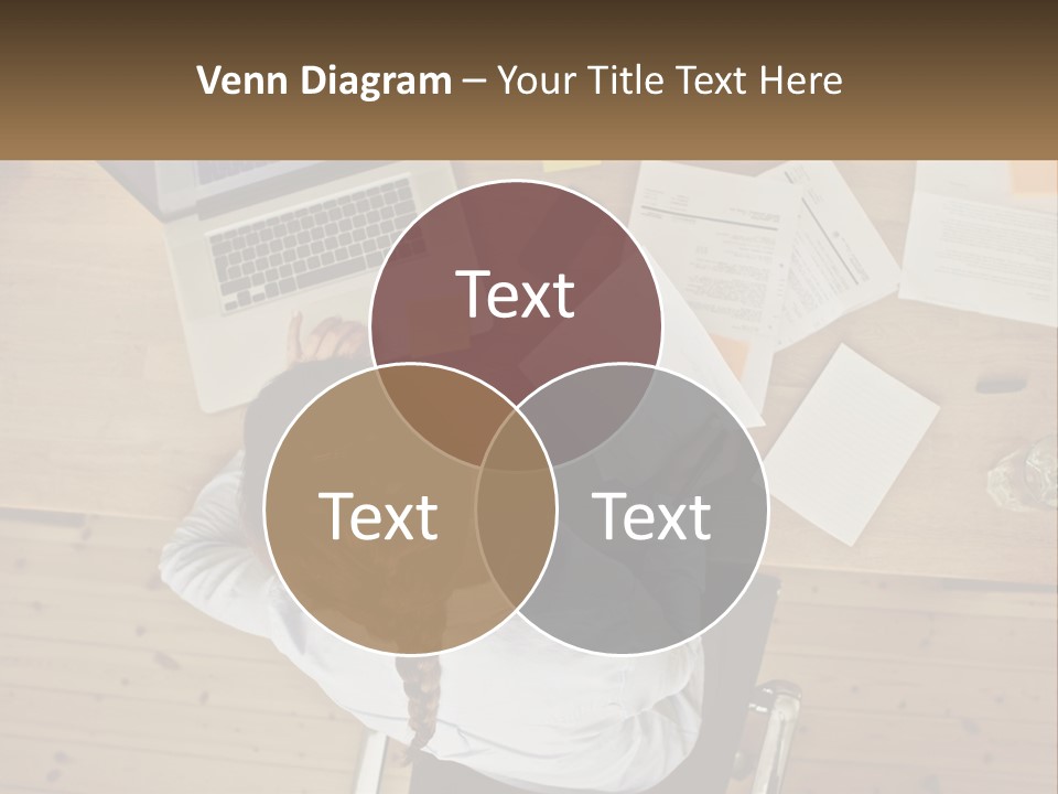 A Woman Sitting At A Desk With A Laptop And Papers PowerPoint Template