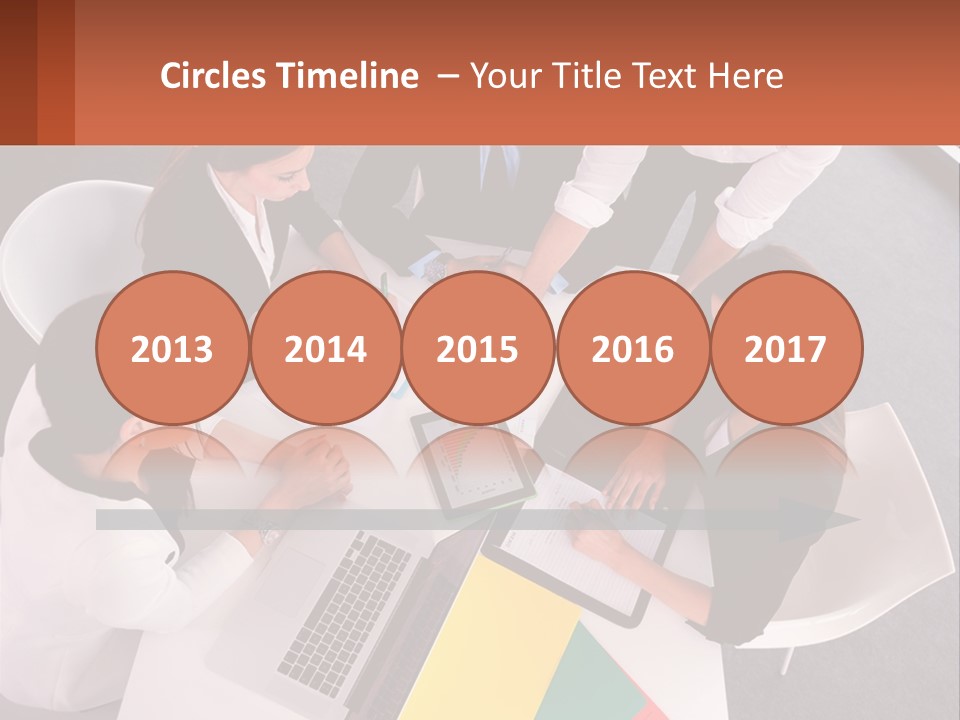 A Group Of Business People Sitting Around A Table PowerPoint Template