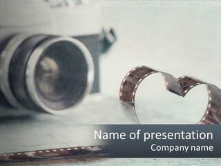 A Film Reel And A Camera On A Table PowerPoint Template