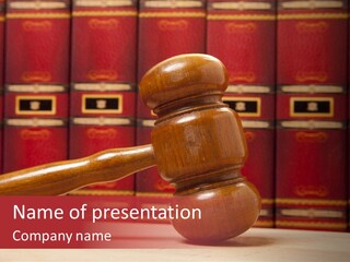 A Wooden Judge's Gavel In Front Of A Row Of Red Books PowerPoint Template