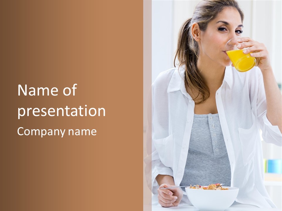 A Woman Drinking Orange Juice While Sitting At A Table PowerPoint Template