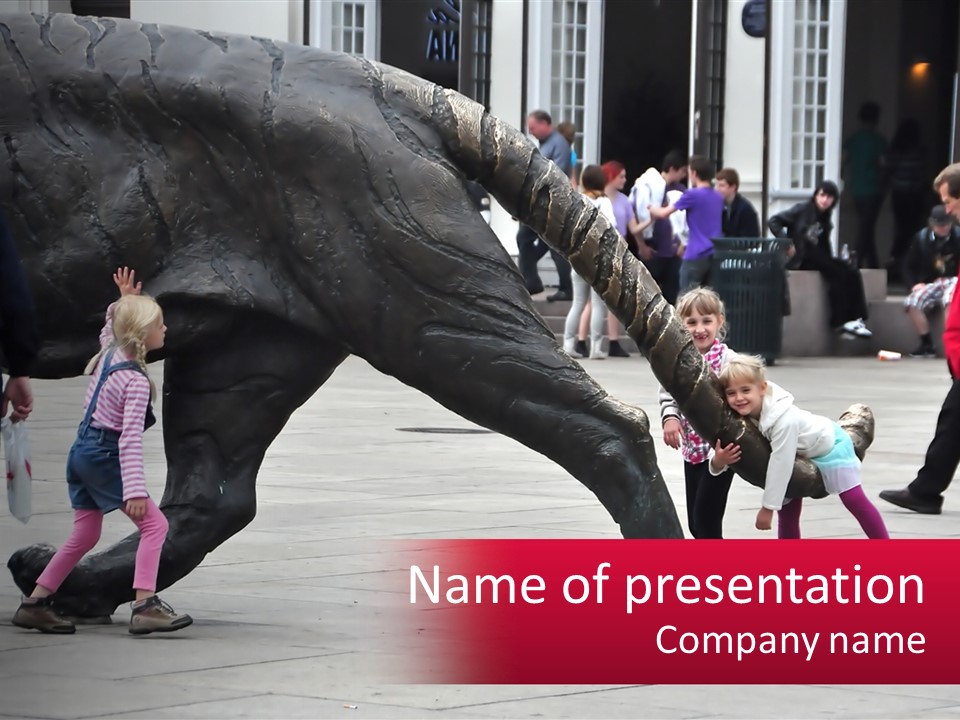 A Group Of Children Playing In Front Of A Statue PowerPoint Template