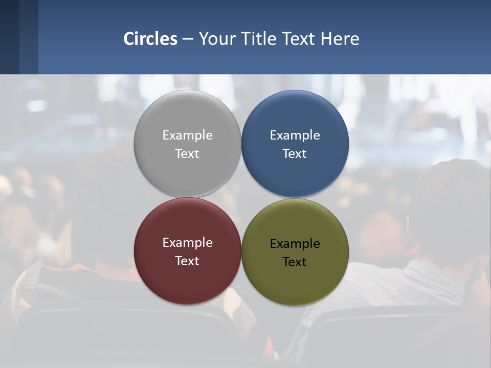 A Group Of People Sitting In Front Of A Stage PowerPoint Template