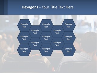 A Group Of People Sitting In Front Of A Stage PowerPoint Template