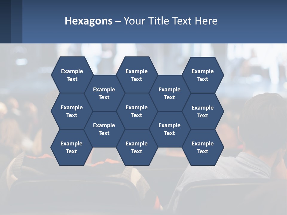 A Group Of People Sitting In Front Of A Stage PowerPoint Template