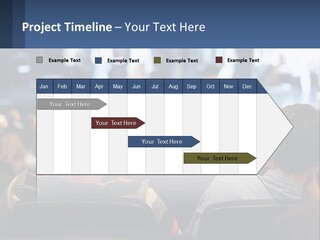 A Group Of People Sitting In Front Of A Stage PowerPoint Template